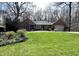 Well-maintained brick home with a large front lawn, mature trees, and an attached garage at 2143 Sunderland Dr, Martinsville, IN 46151
