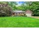 Attractive brick home features a lush lawn, mature trees, and inviting curb appeal at 2143 Sunderland Dr, Martinsville, IN 46151