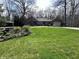 Well-maintained brick home with a large front lawn, mature trees, and a two-car garage at 2143 Sunderland Dr, Martinsville, IN 46151