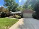 Charming brick home featuring a well-manicured lawn and colorful landscaping with a two car garage at 2143 Sunderland Dr, Martinsville, IN 46151