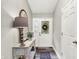 Bright foyer with stylish console table, decor, and wood-look floors at 2143 Sunderland Dr, Martinsville, IN 46151