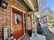 Charming brick home featuring a decorative red front door and cheerful seasonal decor at 2143 Sunderland Dr, Martinsville, IN 46151