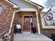 Charming brick home entrance with decorated front door, seasonal flag, and well-manicured landscaping at 2143 Sunderland Dr, Martinsville, IN 46151
