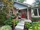 Charming brick home with a red front door and landscaped garden at 2143 Sunderland Dr, Martinsville, IN 46151