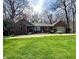 Charming brick ranch-style home with a well-manicured lawn and mature trees creates a welcoming curb appeal at 2143 Sunderland Dr, Martinsville, IN 46151