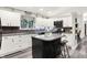 Charming kitchen with white cabinetry, granite countertops, and a dark kitchen island with seating at 2143 Sunderland Dr, Martinsville, IN 46151