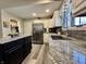 Well-lit kitchen with granite countertops, stainless steel appliances and a modern island with seating at 2143 Sunderland Dr, Martinsville, IN 46151