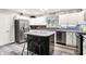 Well-lit kitchen featuring stainless steel appliances, granite countertops, and a dark kitchen island with seating at 2143 Sunderland Dr, Martinsville, IN 46151