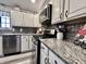 Updated kitchen with granite countertops, modern stainless steel appliances, and stylish cabinetry at 2143 Sunderland Dr, Martinsville, IN 46151