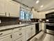 Bright kitchen with white cabinets, granite countertops, stainless steel appliances, and stylish gray subway tile backsplash at 2143 Sunderland Dr, Martinsville, IN 46151