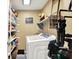 Efficient laundry room with shelving for storage and modern washer and dryer units at 2143 Sunderland Dr, Martinsville, IN 46151