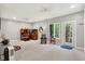 Spacious living room with neutral walls, ceiling fans, and access to the outdoors through a glass door at 2143 Sunderland Dr, Martinsville, IN 46151