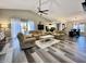 Spacious living room featuring vaulted ceilings, a ceiling fan and ample seating area adjacent to kitchen and dining room at 2143 Sunderland Dr, Martinsville, IN 46151