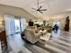 Open living room featuring a vaulted ceiling, ceiling fan, and sliding glass doors to the outside at 2143 Sunderland Dr, Martinsville, IN 46151