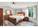 Spacious main bedroom features neutral tones, a ceiling fan, and a large window with a green view at 2143 Sunderland Dr, Martinsville, IN 46151