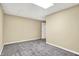Empty room with neutral walls, carpet flooring, and a door to another room at 2143 Sunderland Dr, Martinsville, IN 46151