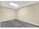 Empty room with neutral walls, carpet flooring, and bright lighting at 2143 Sunderland Dr, Martinsville, IN 46151