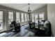 Bright sunroom featuring a vaulted ceiling, multiple windows, and access to an outdoor deck at 2143 Sunderland Dr, Martinsville, IN 46151