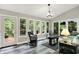 Bright sunroom with large windows offering natural light and views of the outdoor deck at 2143 Sunderland Dr, Martinsville, IN 46151