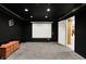 Theater room with black walls, ceiling, a projection screen, and a wooden TV stand at 2143 Sunderland Dr, Martinsville, IN 46151