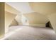 Spacious attic with patterned walls and carpeting, offering a flexible living space at 2309 Pearl St, Columbus, IN 47201