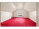 Finished attic featuring bright red carpet and a dormer window at 2309 Pearl St, Columbus, IN 47201