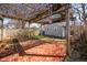 Relaxing backyard area featuring brick patio and a pergola covered with climbing vines at 2309 Pearl St, Columbus, IN 47201