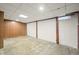 A partially finished basement space with paneled walls, concrete flooring, and a drop ceiling at 2309 Pearl St, Columbus, IN 47201