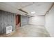 Partially finished basement featuring paneled walls, a brick accent wall, and carpeted stairs at 2309 Pearl St, Columbus, IN 47201