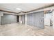 Spacious unfinished basement with wood paneled walls, concrete floors, and laundry hook-ups at 2309 Pearl St, Columbus, IN 47201
