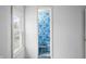A view from the bedroom of the blue floral themed bathroom featuring the matching toilet and carpet at 2309 Pearl St, Columbus, IN 47201