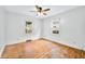 Spacious bedroom featuring hardwood floors, white walls, and bright windows at 2309 Pearl St, Columbus, IN 47201