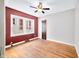 Bedroom featuring hardwood floors, two windows, and contrasting wall colors at 2309 Pearl St, Columbus, IN 47201