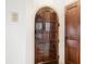 Arched entryway door crafted with dark wood, offering classic charm and character to this home at 2309 Pearl St, Columbus, IN 47201