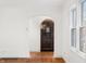 View of arched entry door and white walls and tile floor providing a smooth transition to the home at 2309 Pearl St, Columbus, IN 47201