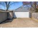 Exterior view of the detached garage with white door and fenced yard at 2309 Pearl St, Columbus, IN 47201