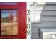 Close up of house number on charming gray home with a red arched front door at 2309 Pearl St, Columbus, IN 47201