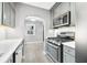 Well-equipped kitchen featuring stainless steel appliances, gray cabinetry, and modern design at 2309 Pearl St, Columbus, IN 47201