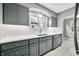 Modern kitchen with sleek gray cabinets, quartz countertops, and stainless steel appliances at 2309 Pearl St, Columbus, IN 47201