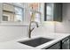Close-up of a modern kitchen sink with subway tile backsplash and a view through the windows at 2309 Pearl St, Columbus, IN 47201