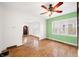 Charming living room featuring hardwood floors, bright green walls, and arched doorways at 2309 Pearl St, Columbus, IN 47201