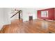 View of living room with hardwood flooring, white trim, fireplace and natural light from the windows at 2309 Pearl St, Columbus, IN 47201