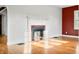 Sunlit living room featuring a charming fireplace, hardwood floors, and a warm, inviting atmosphere at 2309 Pearl St, Columbus, IN 47201