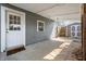 Covered patio with door to the home and a view of backyard shed at 2309 Pearl St, Columbus, IN 47201