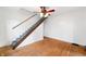 Carpeted staircase featuring hardwood floors and an overhead ceiling fan, showcasing a cozy design at 2309 Pearl St, Columbus, IN 47201