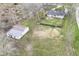Aerial view of the property showing house, barn, fenced yard, and surrounding landscape at 2420 Goose Creek Rd, Martinsville, IN 46151