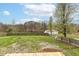Large backyard with a wooden fence, fire pit, and lush greenery, perfect for outdoor enjoyment at 2420 Goose Creek Rd, Martinsville, IN 46151