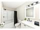 Clean bathroom featuring a tub-shower combo, a white vanity, and elegant black fixtures at 2420 Goose Creek Rd, Martinsville, IN 46151