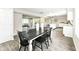 Open concept dining room with a white and black table, view of the kitchen and the adjoining living room at 2420 Goose Creek Rd, Martinsville, IN 46151