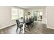 Cozy dining room with wood floors, a contemporary light fixture, and a large window overlooking the yard at 2420 Goose Creek Rd, Martinsville, IN 46151